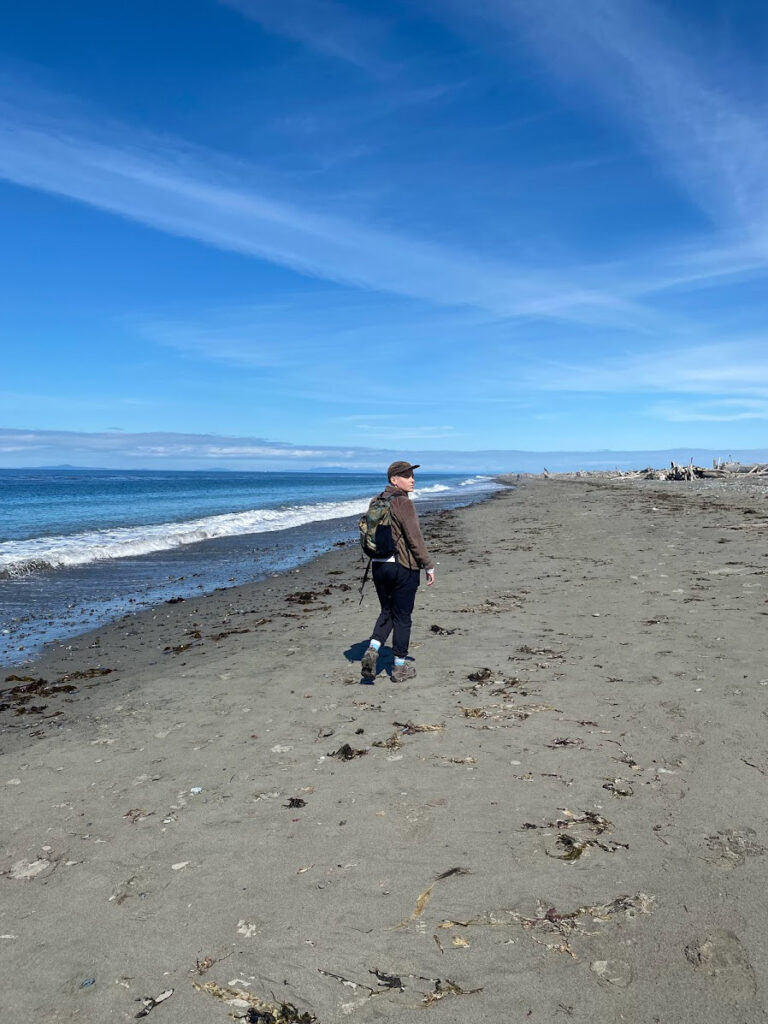 woman hiking on a beach